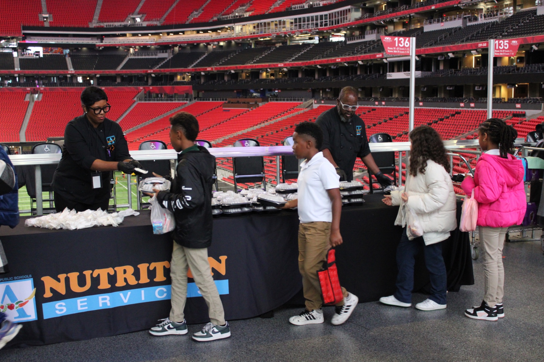 APS Nutrition Services staff serving students at the Chew Crew Student Menu Focus Group inside Mercedes-Benz Stadium
